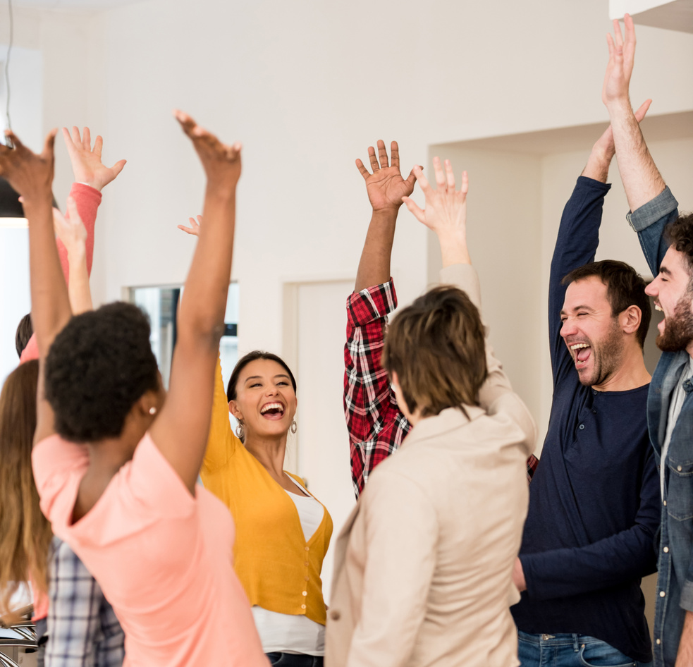 Excited group of people celebrating an achievement at the office